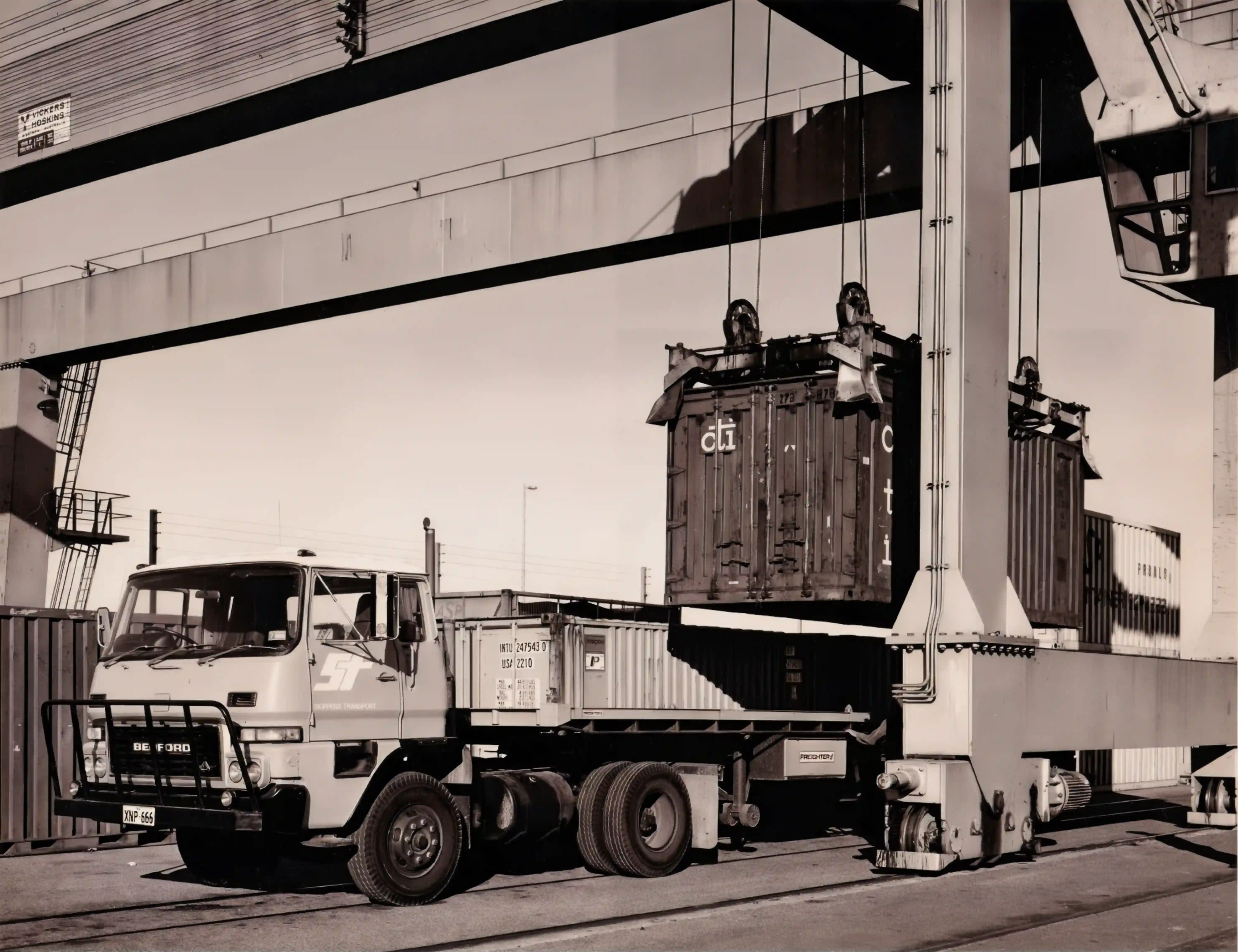 a picture of a skippers truck being loaded with a container in the 1960s for skippers Western Australia's Longest Running Transport Company